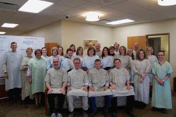 large group of people in hospital gowns